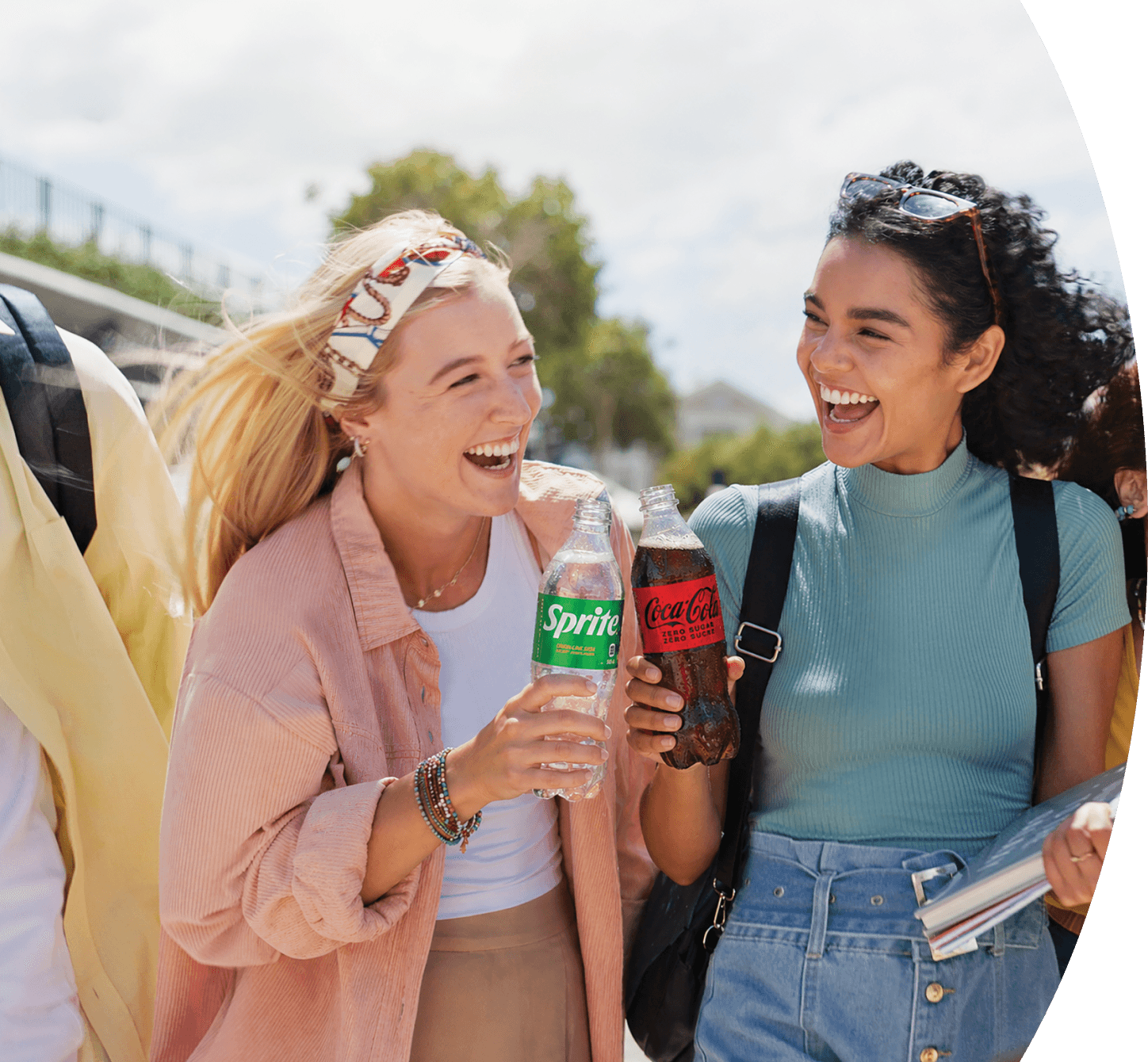 Two people with Sprite and Coca-Cola® bottles